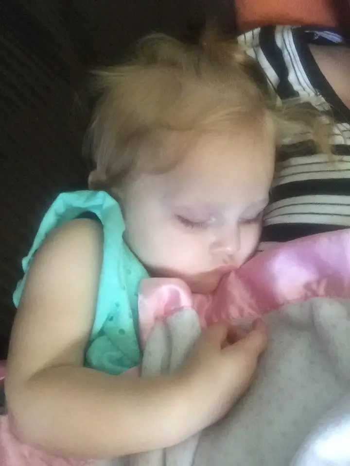 Baby having food reaction, sleeping with blanket