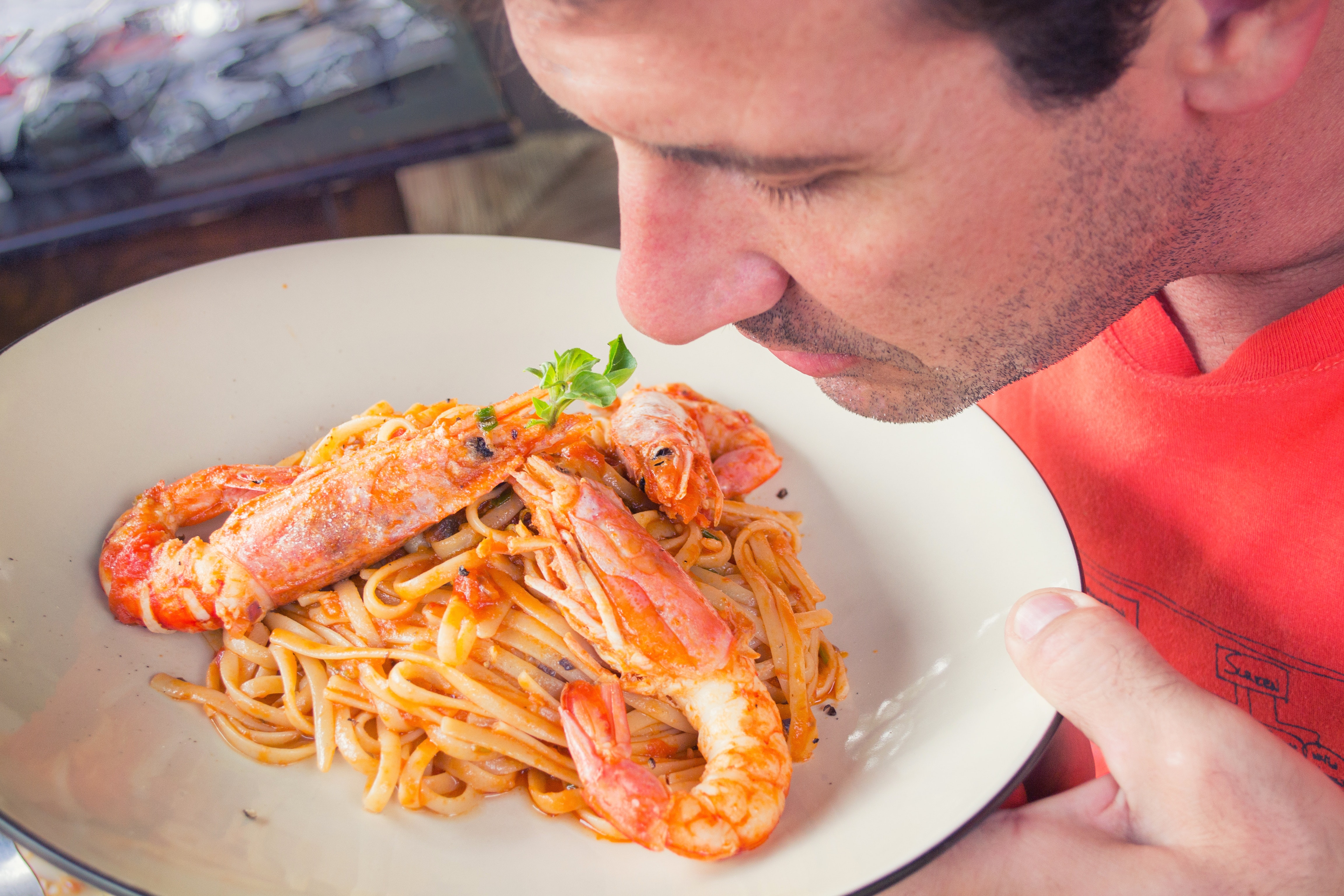 Man Smelling Plate of Shellfish FPIES Allergy