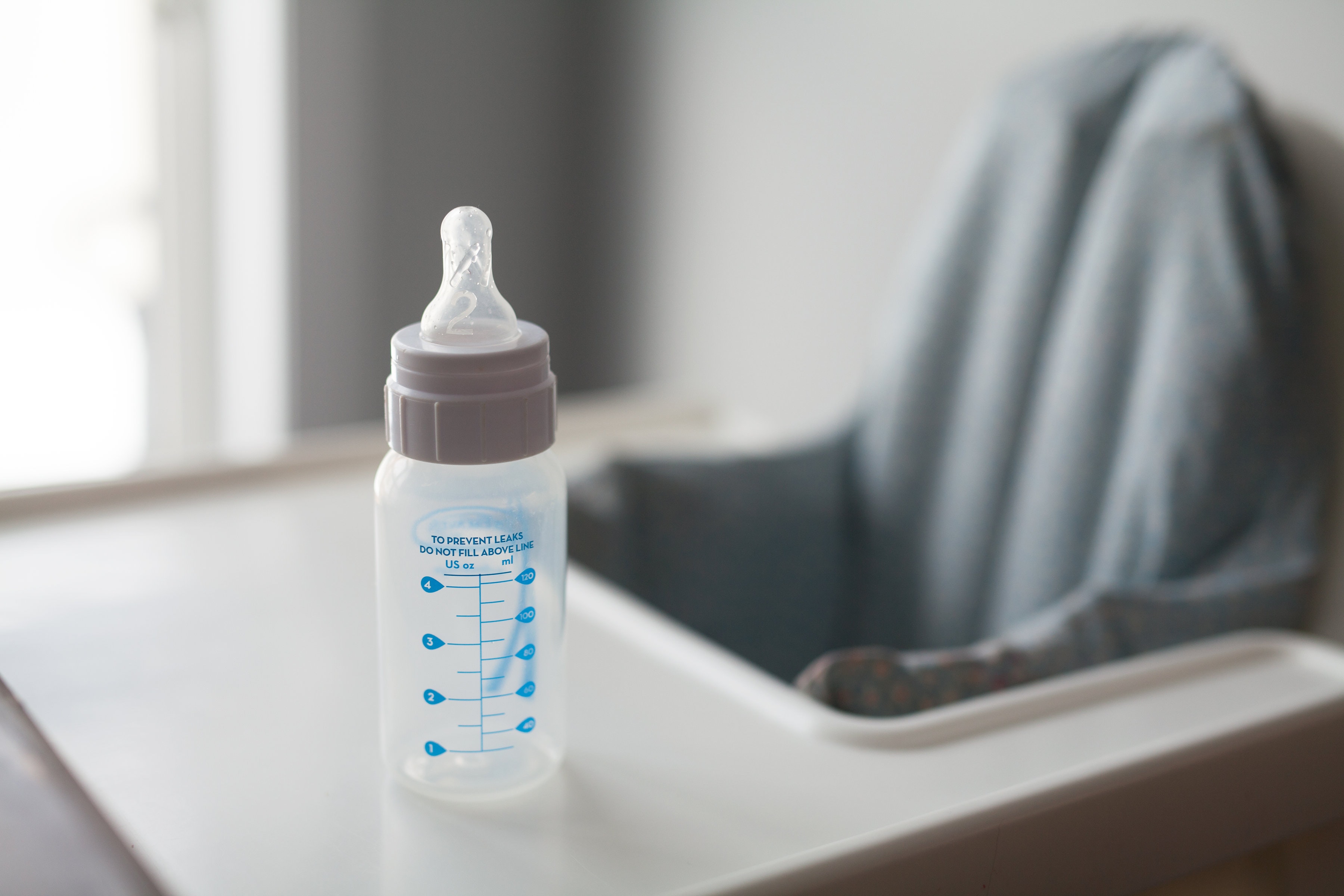 Empty baby bottle - helping baby take formula