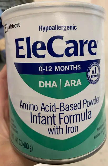 Can of green Elecare Infant formula